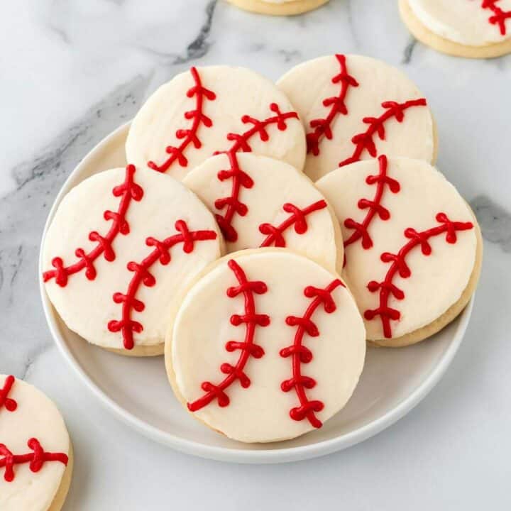 baseball sugar cookies on white glass plate