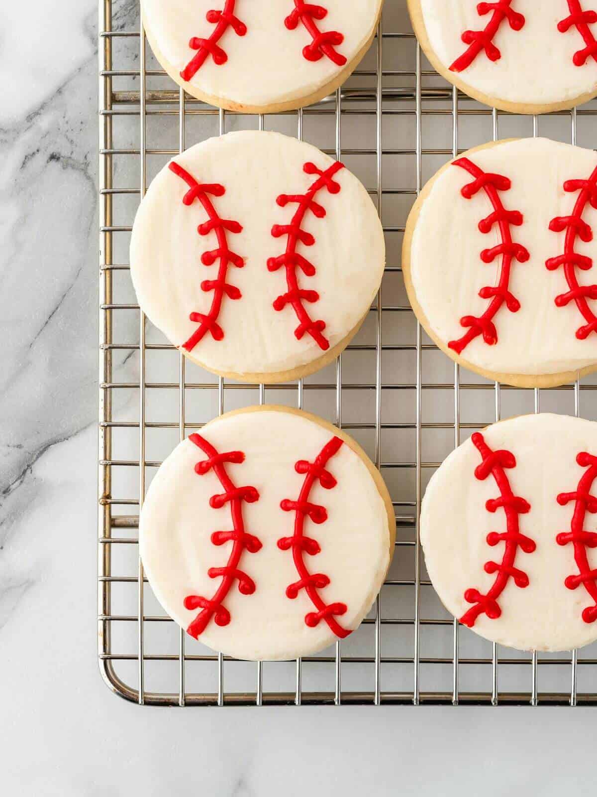 baseball sugar cookies on wire cooling rack