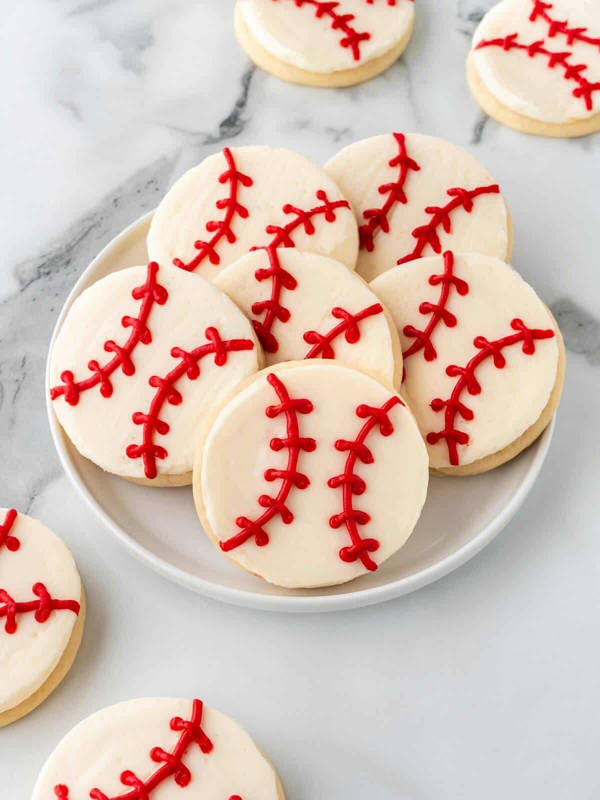 baseball sugar cookies on white glass plate