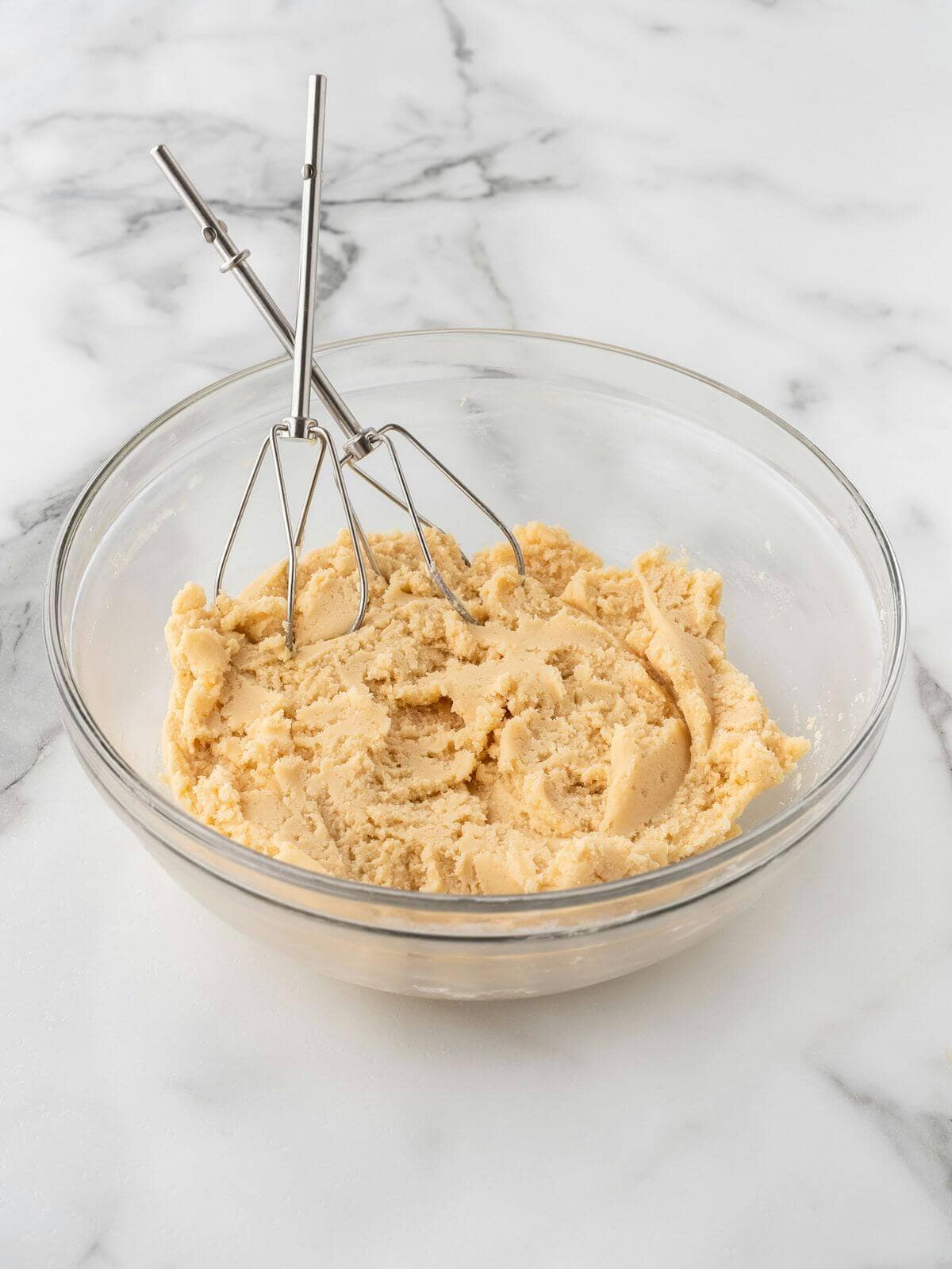 raw sugar cookie in glass mixing bowl