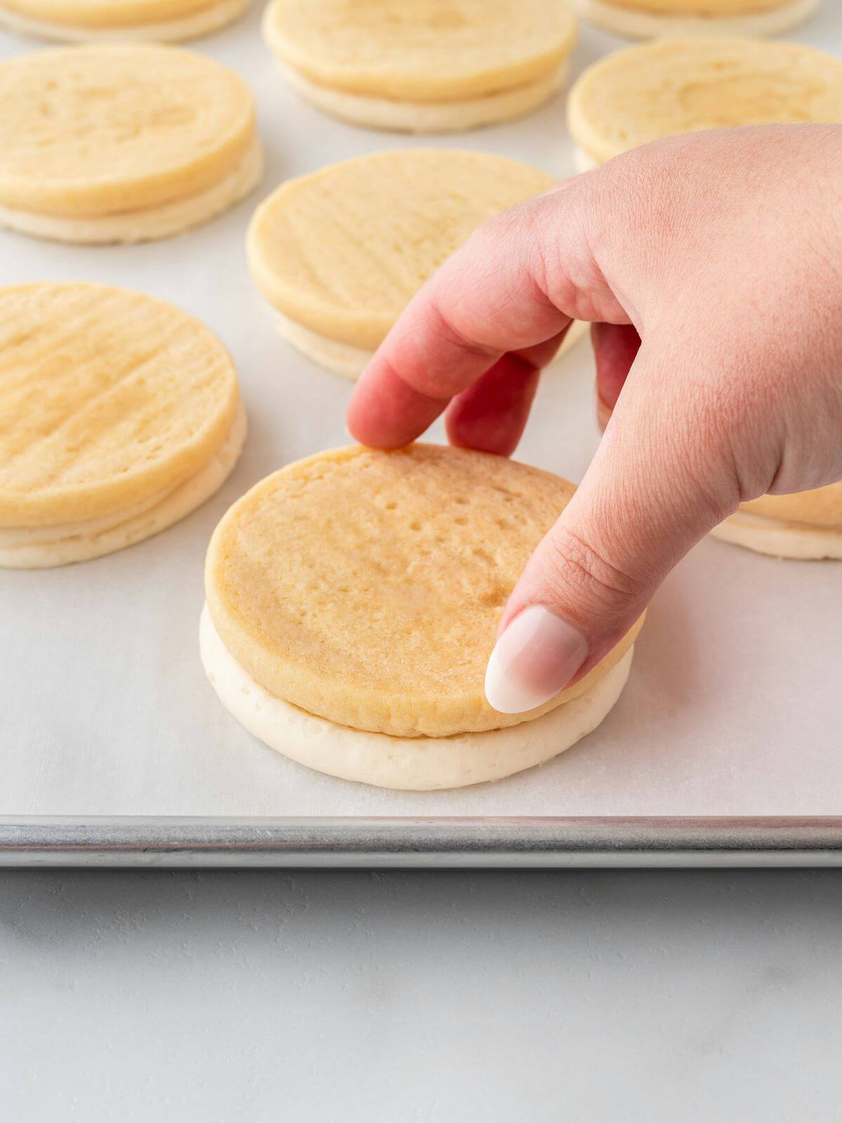 sugar cookie flipped upside down on parchment lined paper sheet