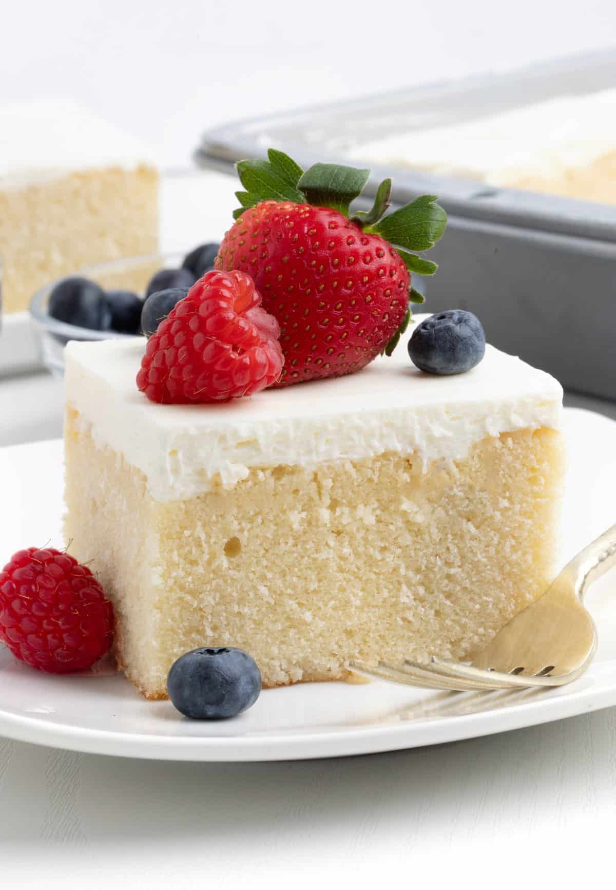 square slice of berry white chantilly cake from 9x13" pan