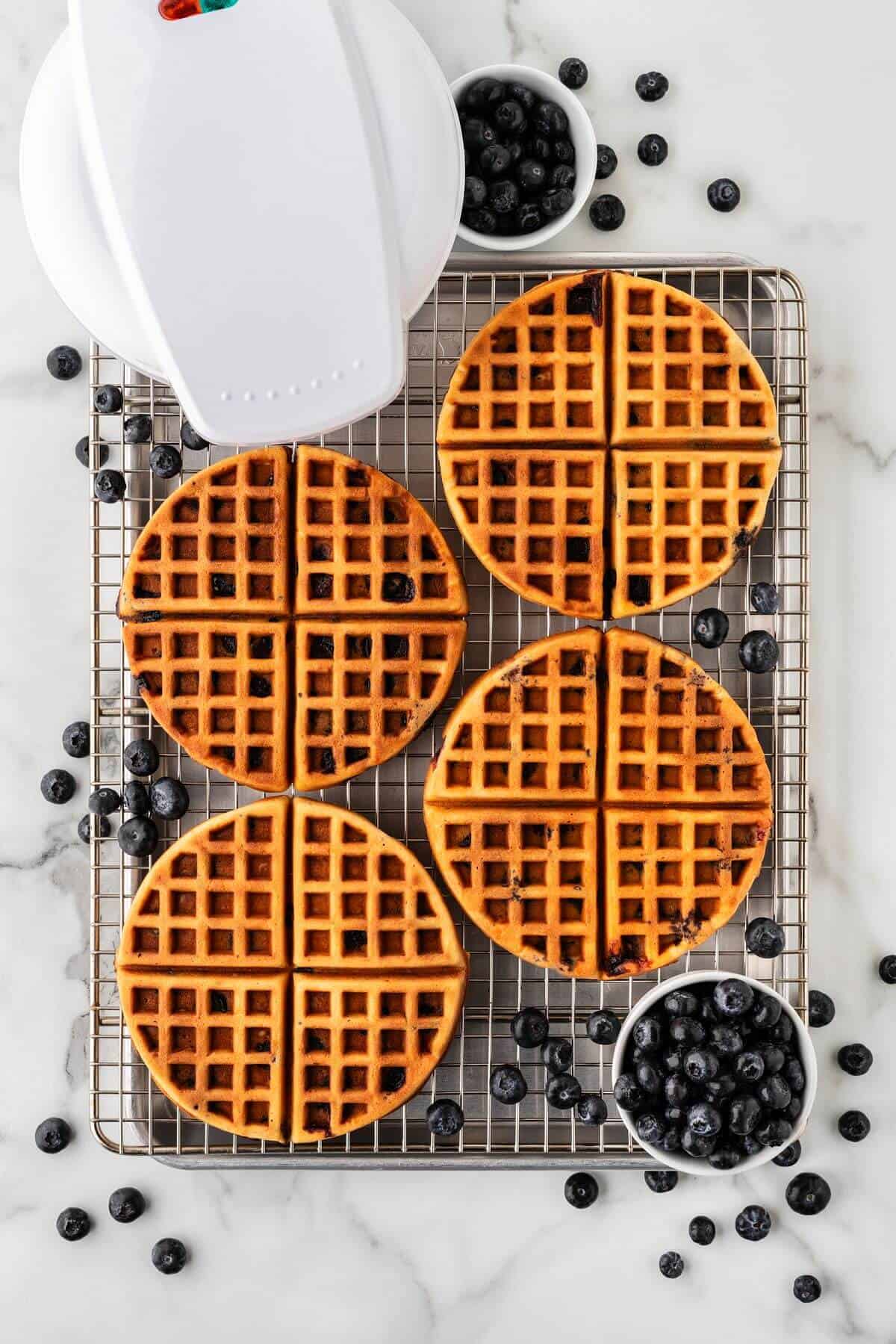 Blueberry waffles on wire rack.