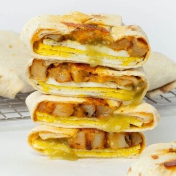 two breakfast crunchwraps cut in half stacked on top of each other