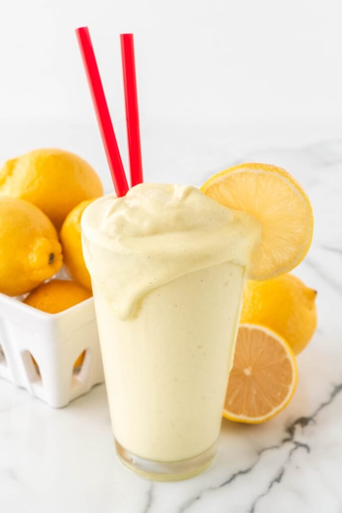 Glass of copycat chickfila frosted lemonade with red straws