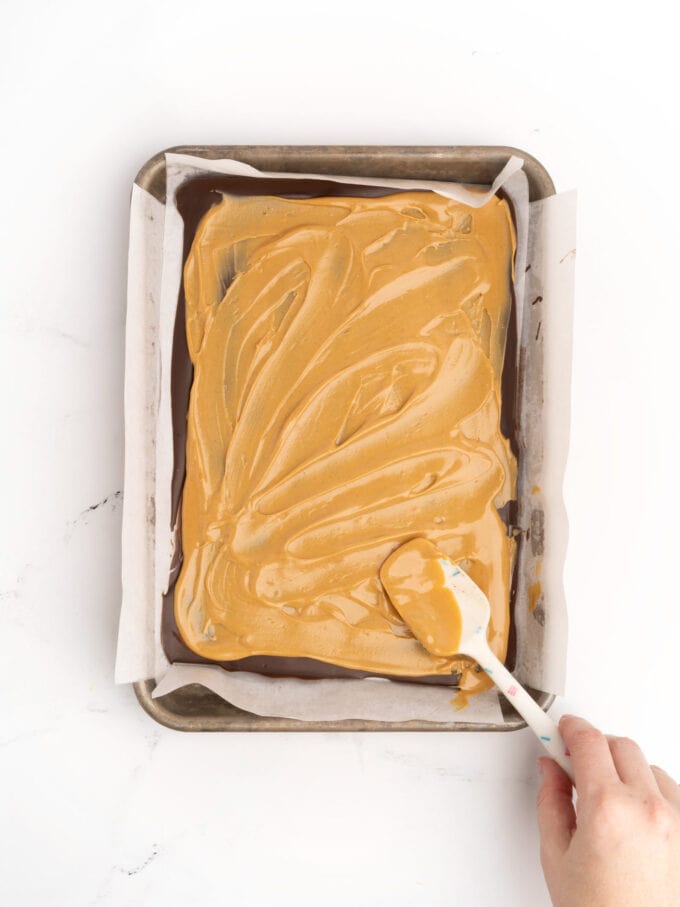 spreading peanut butter on chocolate bark