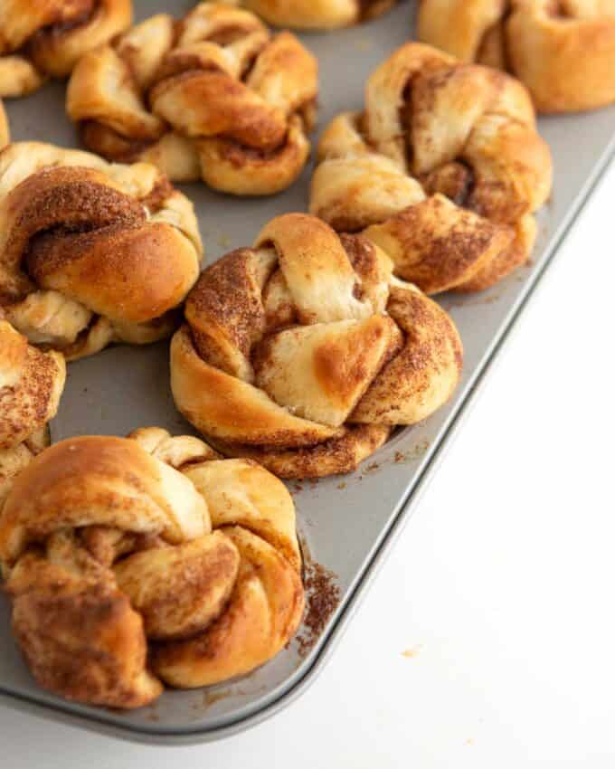 unbaked cinnamon roll muffin dough brushed with milk