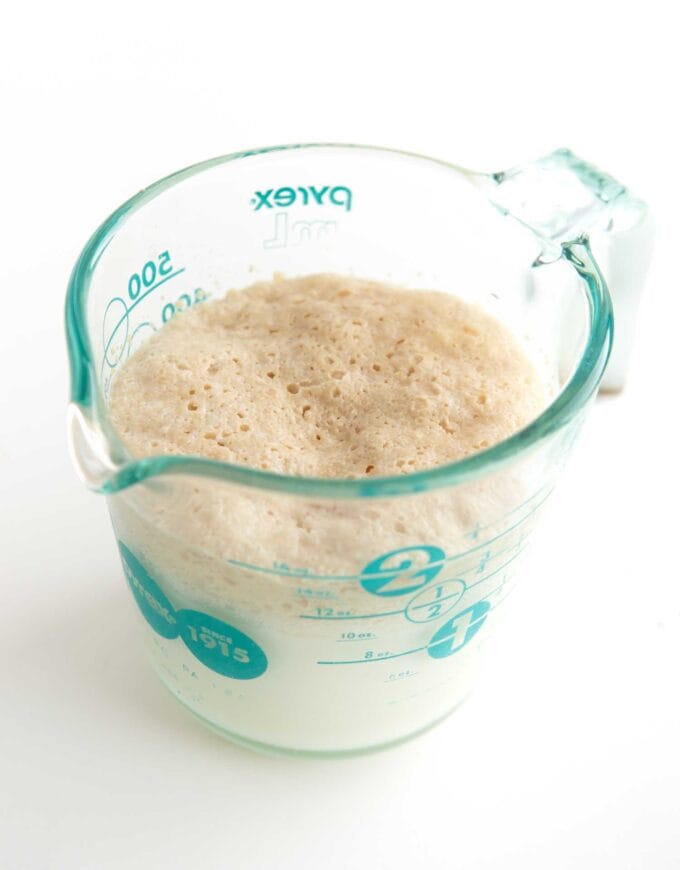 glass measuring cup with bloomed yeast