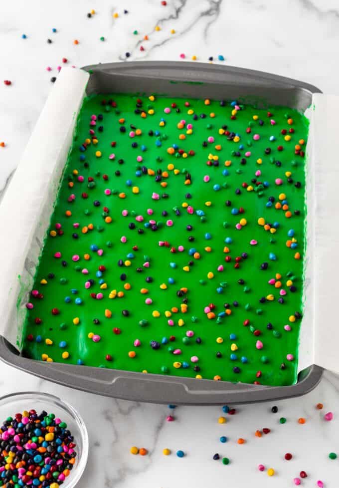 pan of cosmic brownies with white chocolate ganache and rainbow chip sprinkles