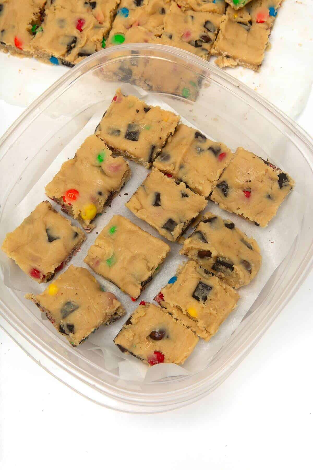 Frozen cookie dough squares in to plastic container.