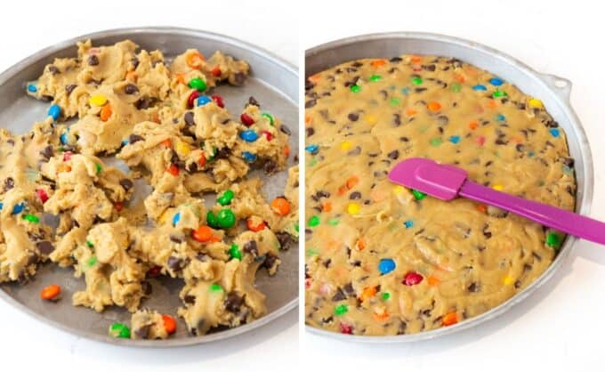 Pressing M&M cookie cake dough into round cookie cake pan