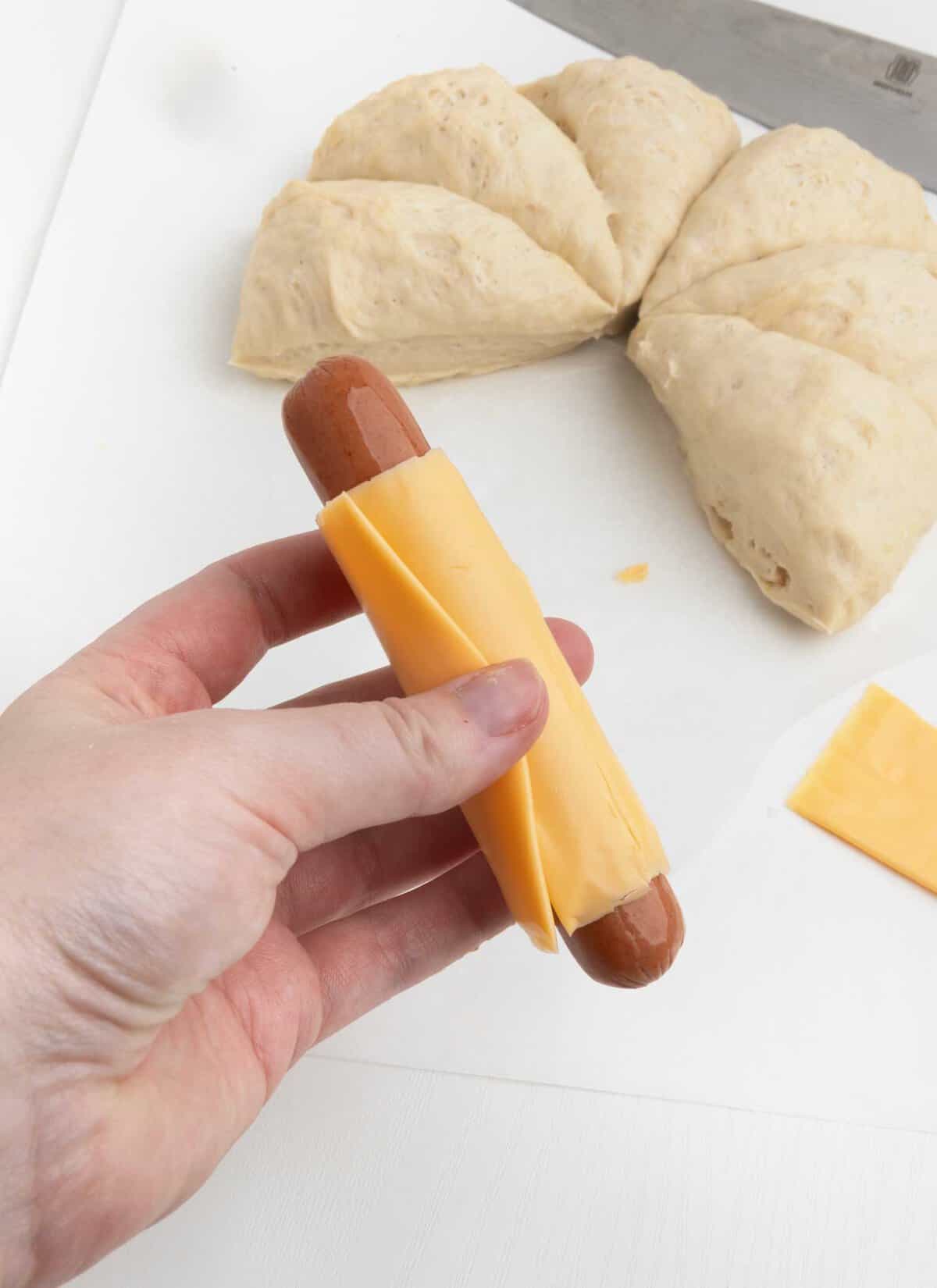 wrap hotdog with slice of kraft cheese
