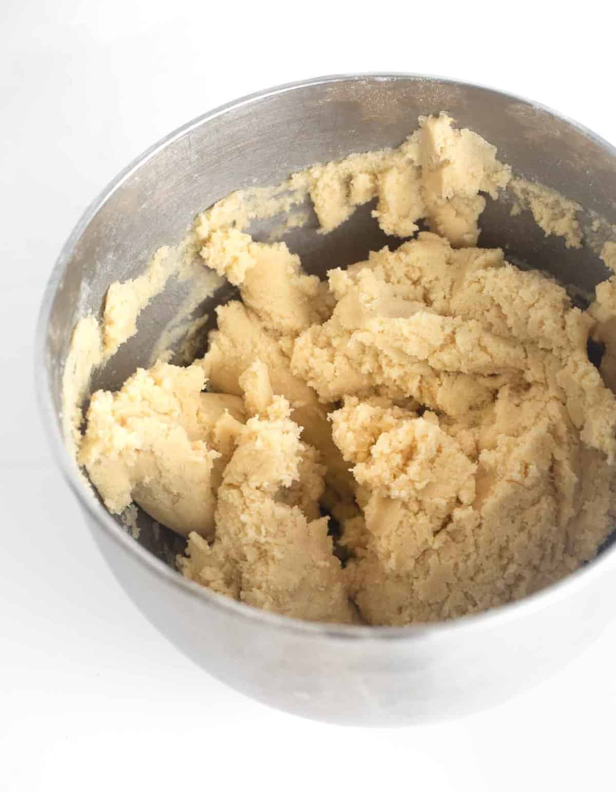 sugar cookie bar dough in metal mixing bowl