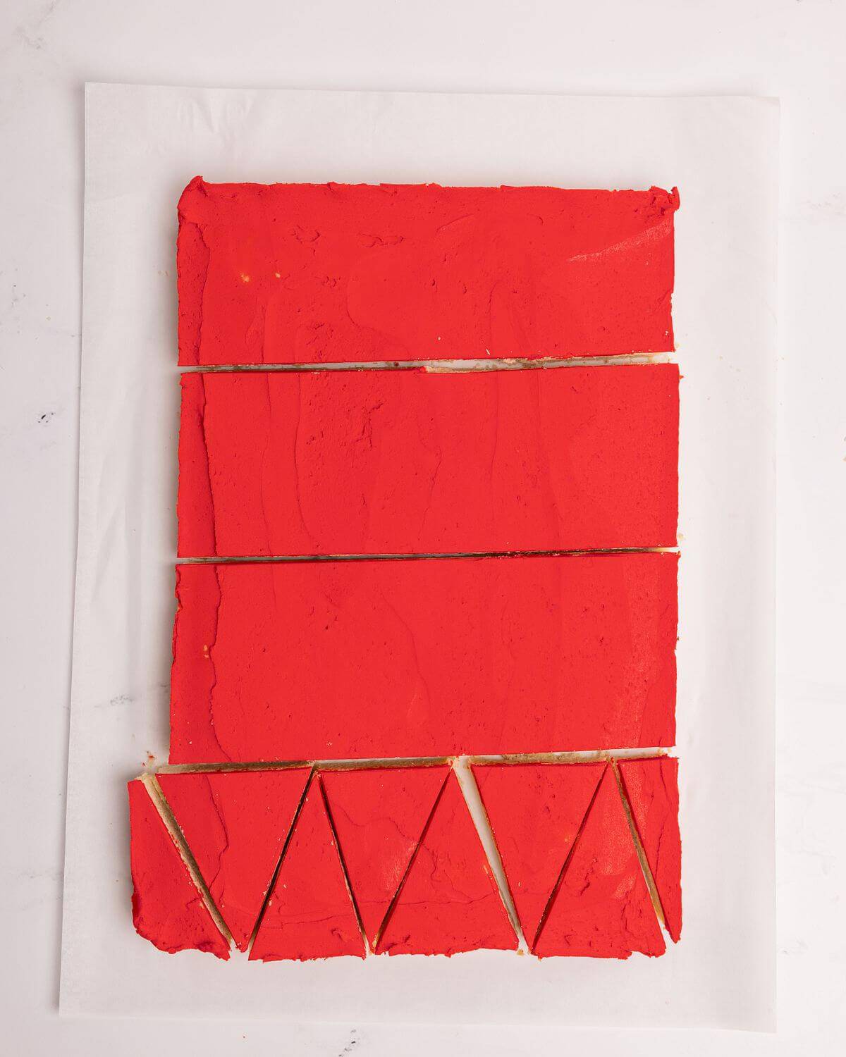 cutting frosted sugar cookie bars into individual triangles
