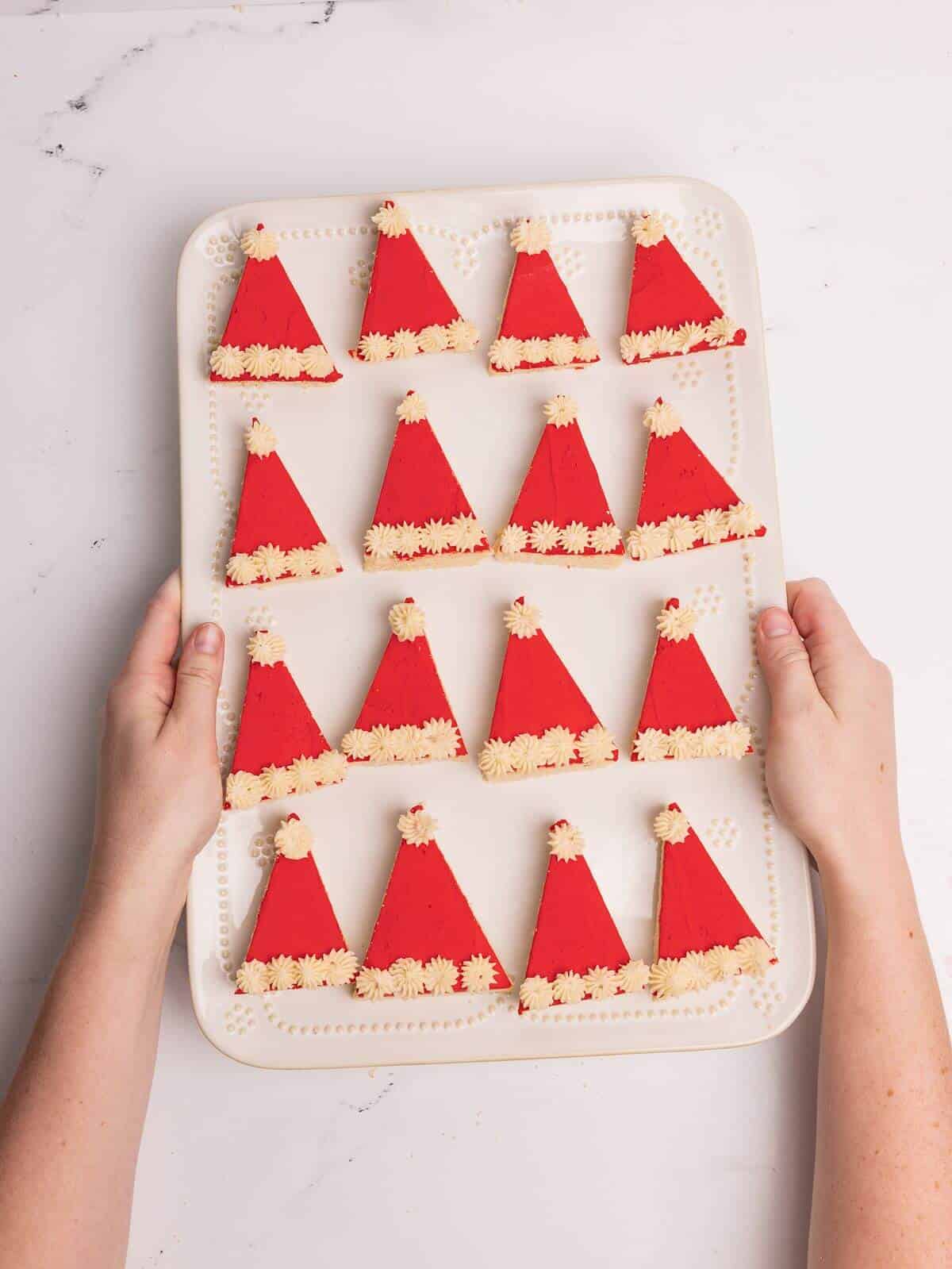 santa hat sugar cookie bars on white serving tray