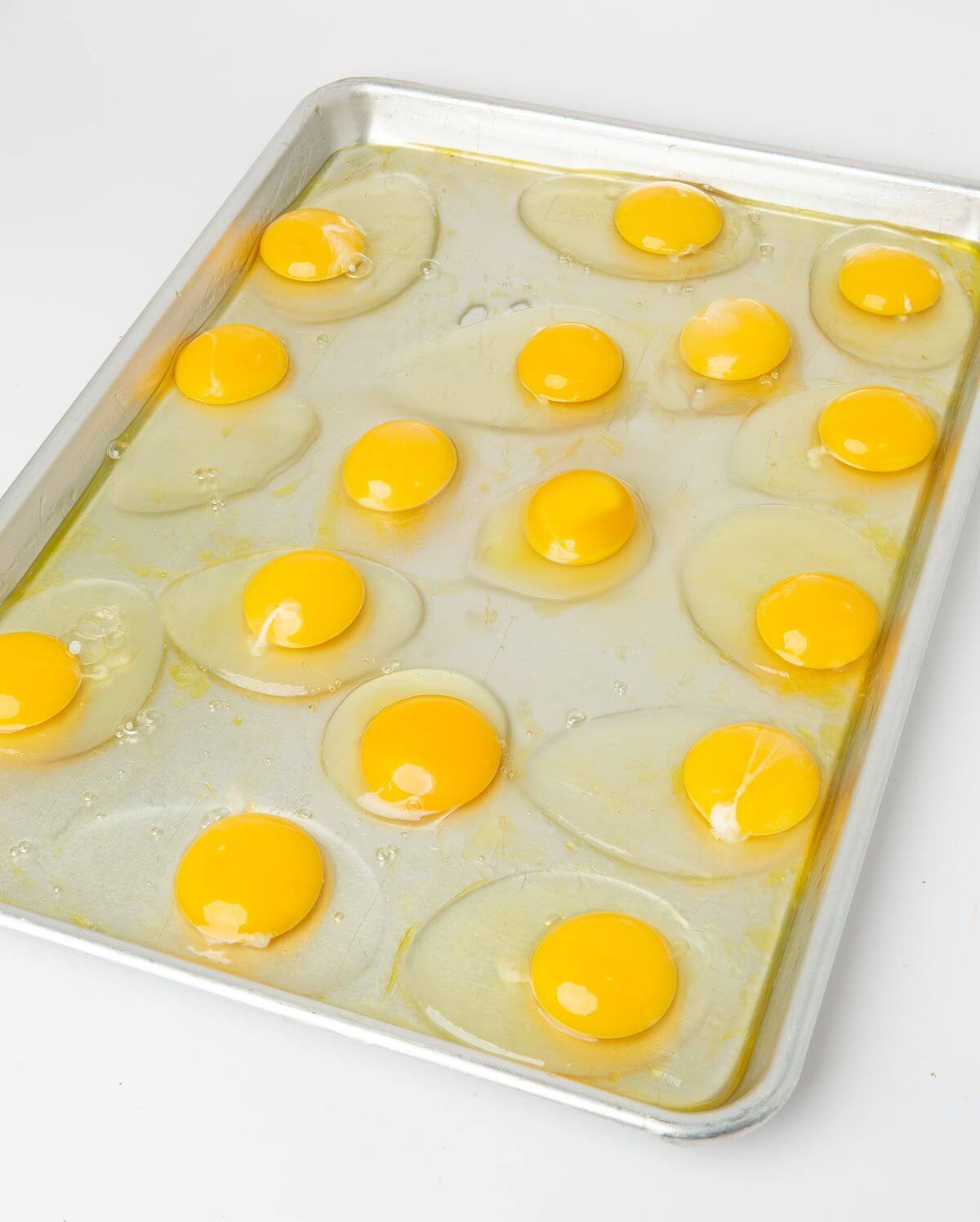 16 large eggs cracked on half sheet pan