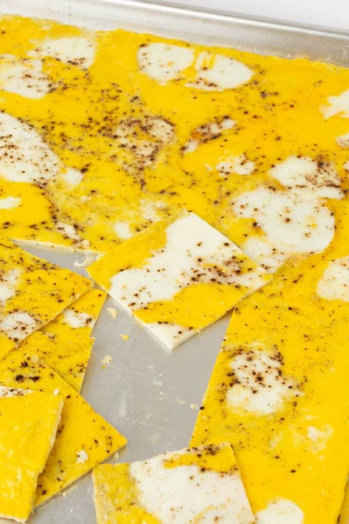 sheet pan eggs cut into squares on rimmed baking sheet