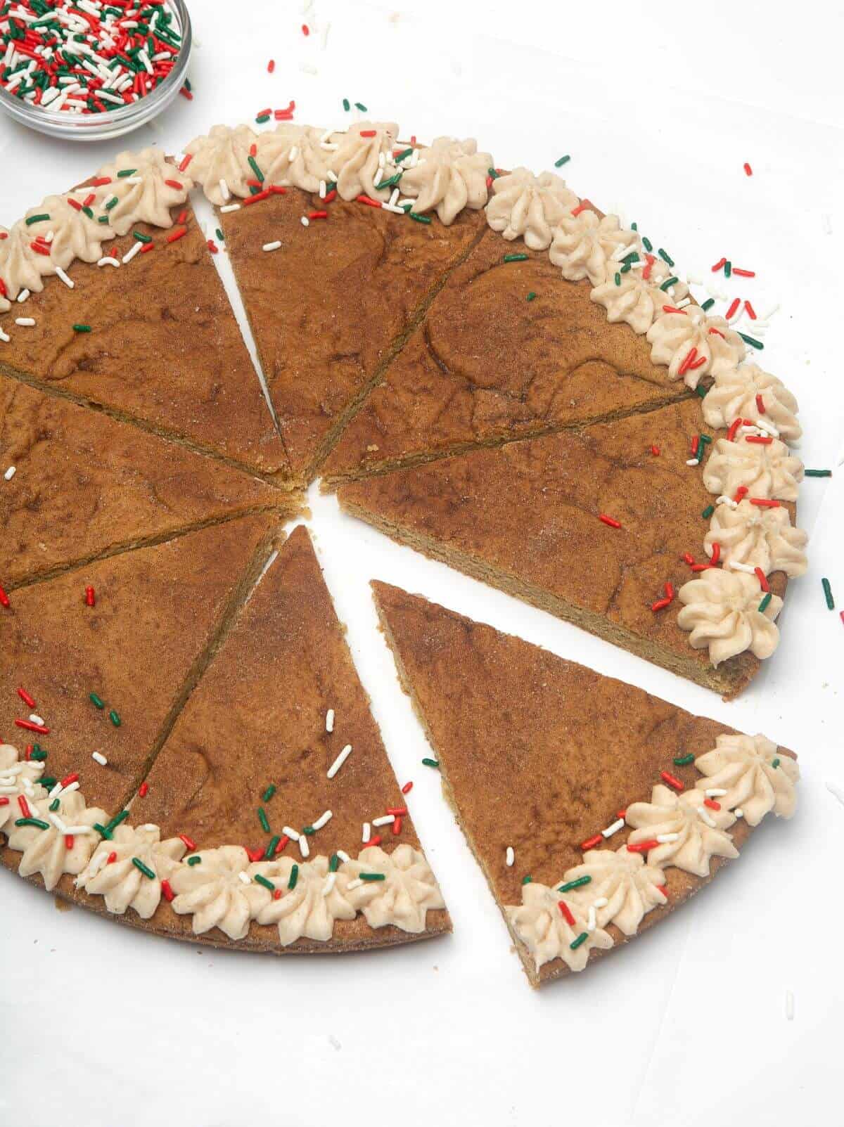 Snickerdoodle cookie cake cut into slices.