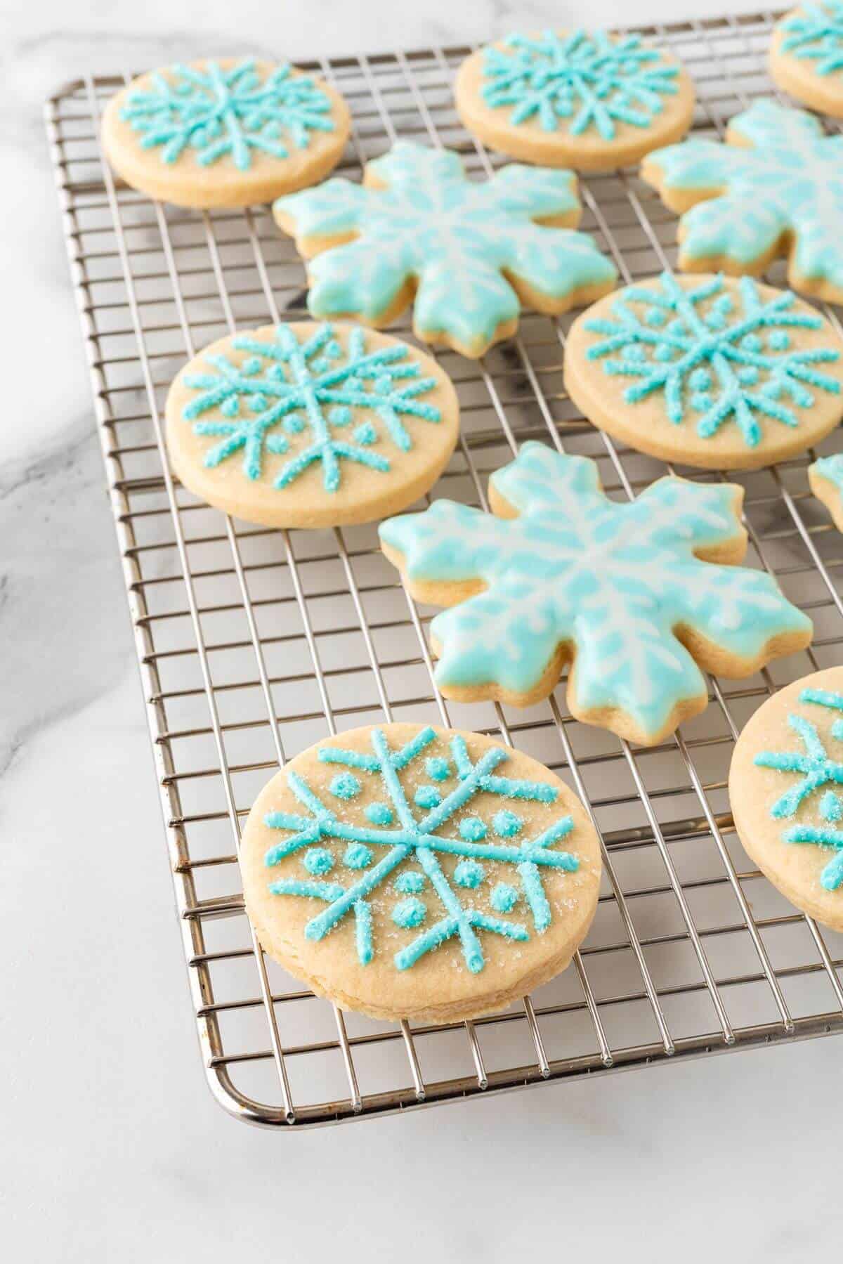 snowflake sugar cookies cooling on cooling rack