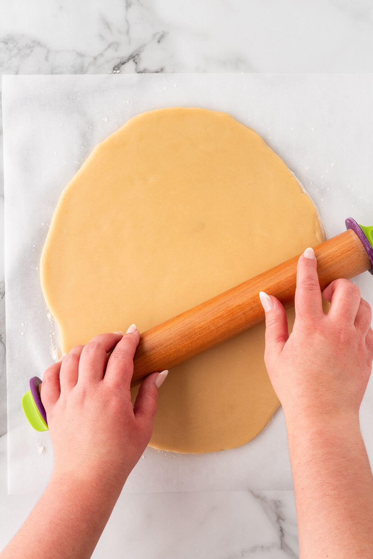 rolling sugar cookie dough out with rolling pin