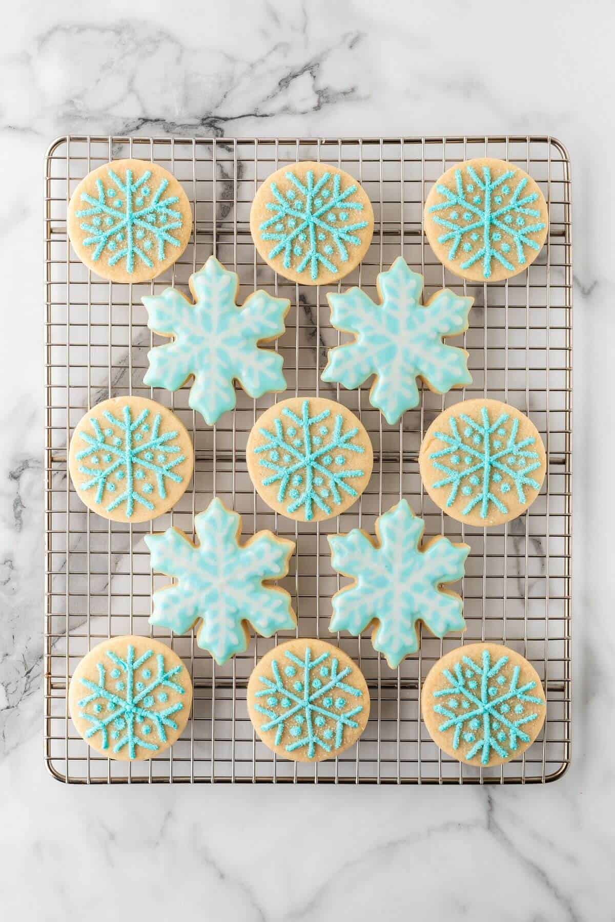 frosted snowflake sugar cookies on cooling rack