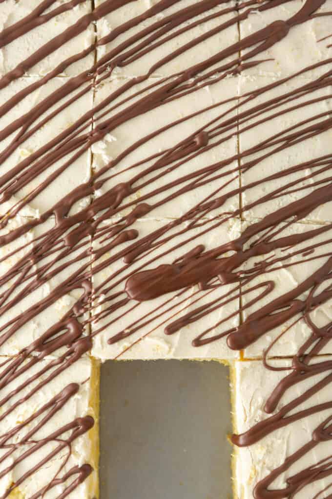 Overhead view of sliced squares of homemade zebra cake, with one square removed