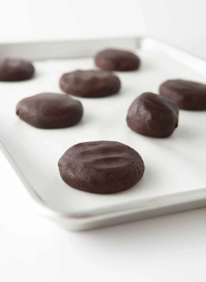 andes mint cookie dough balls slightly flattened on cookie tray